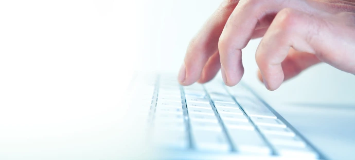 Fingers typing on a computer keyboard